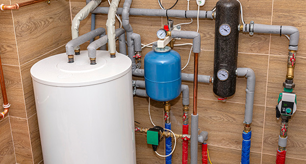 water heater and plumbing system with pipes and gauges in a modern installation